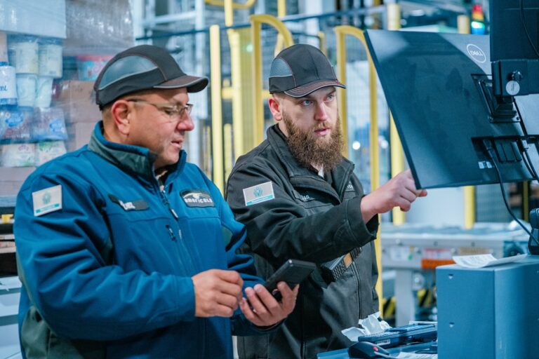 workers looking at computer and phone