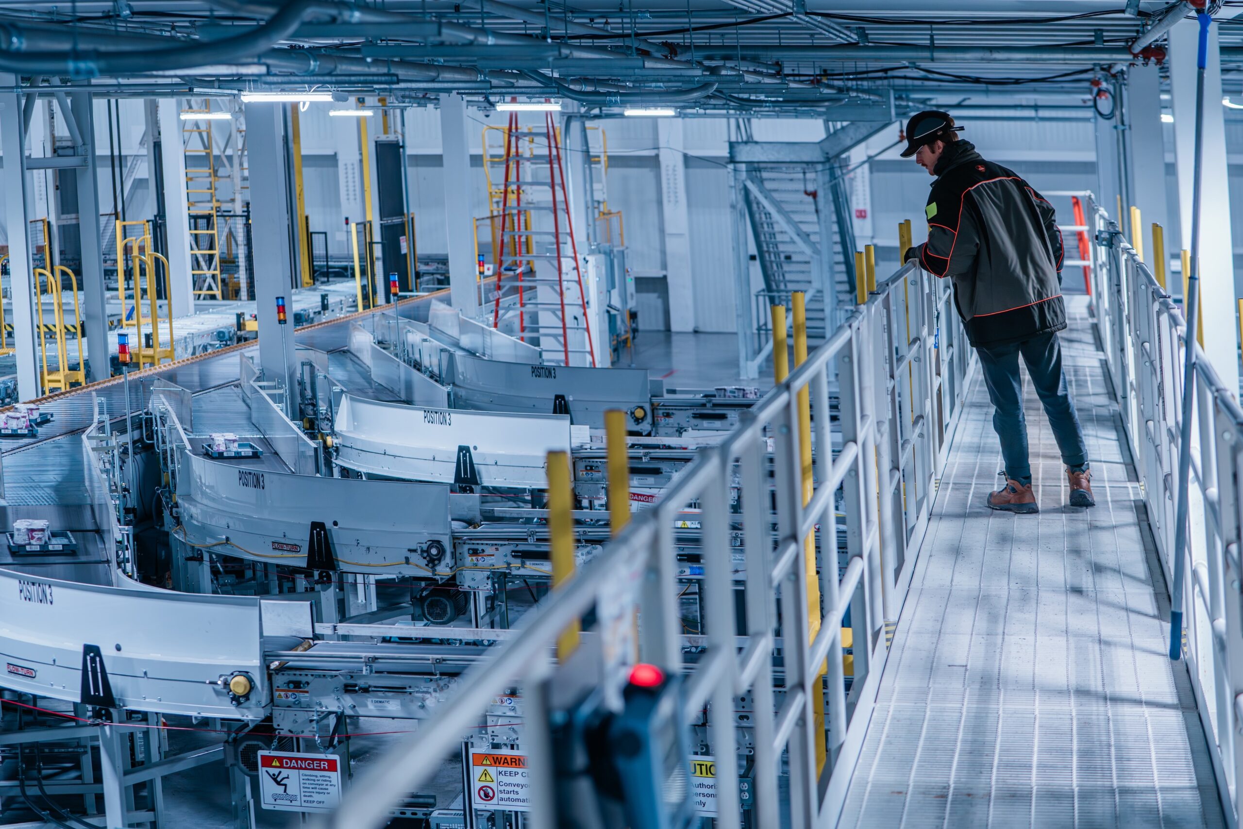 Worker peering into facility from walkway