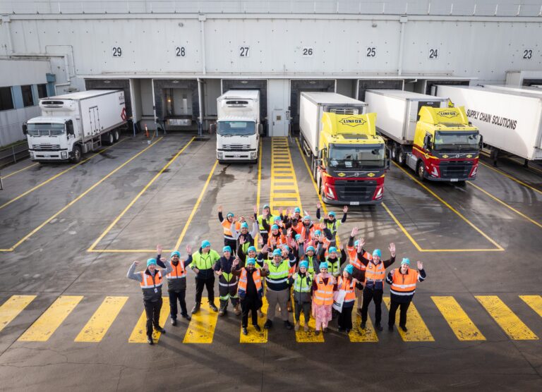 americold workers standing outside facility smiling