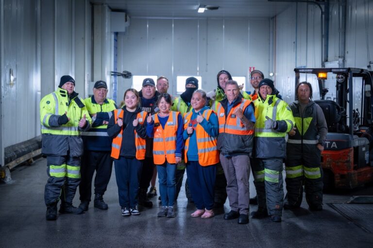 Americold workers standing together and smiling