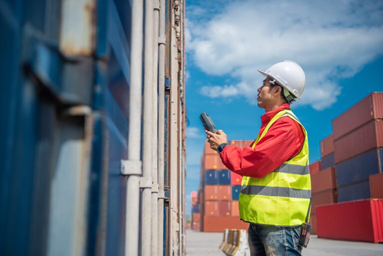 Americold employee inspecting containers