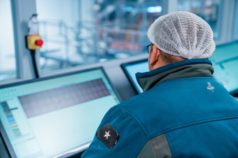 facility worker monitoring computer screen