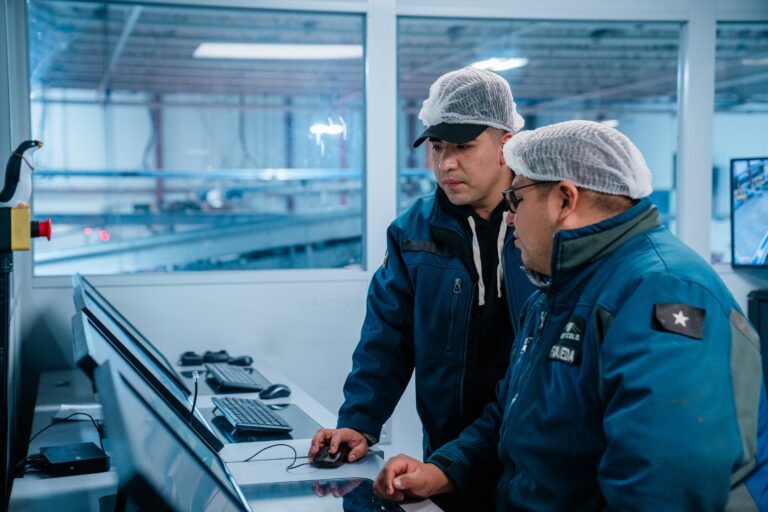 workers with hairnets on computers