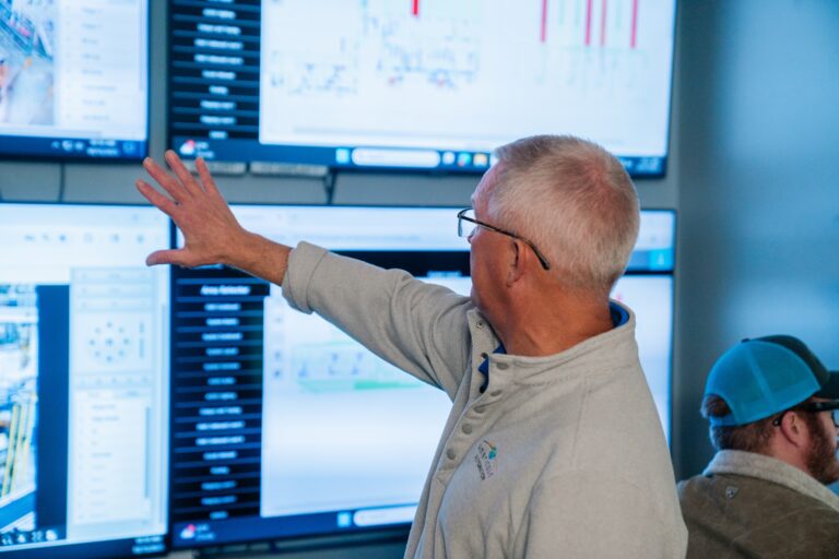 man monitoring computer screens