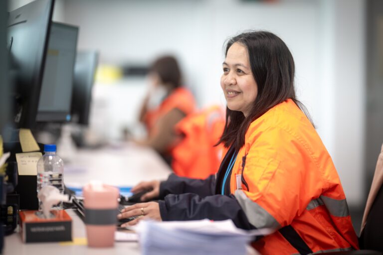 woman working at desk smiling