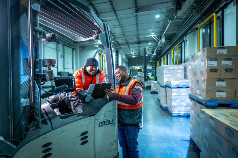 two workers looking at a clipboard